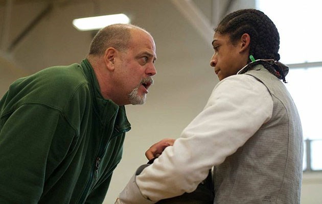 Michael Corona mentors a fencer during practice